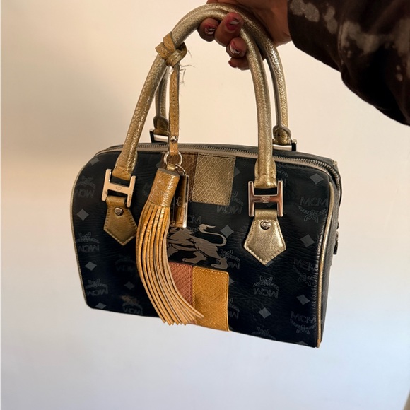 MCM Handbags - MCM Black and Gold Satchel with Tassel